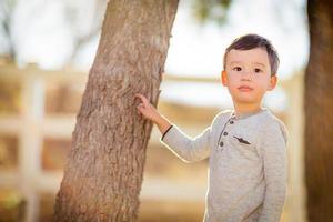 Outdoor portrait of a mixed race Chinese and Caucasian boy. photo