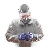 Man Wearing Hazmat Suit, Goggles and Gas Mask Isolated On White. photo