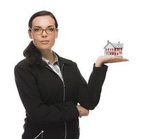 Mixed Race Businesswoman Holding Small House to the Side photo