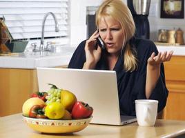 Woman on Cell Phone and Laptop photo