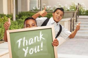 Boys Giving Thumbs Up Holding Thank You Chalk Board photo