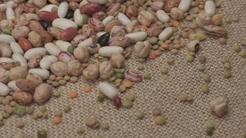 Dry legumes rotating on jute background. Beans healthy protein diet, Mediterranean vegan vegetarian diet nutrition video