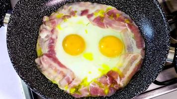 Delicious bacon eggs cooking in timelapse. Tasty food for English breakfast.Cooking in a pan.
