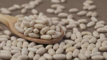 White beans legumes on wooden spoon video