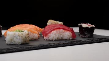 Sushi assortment with salmon nigiri, tuna nigiri, hosomaki and uramaki. Raw fish maki and rice Japanese Asian food.