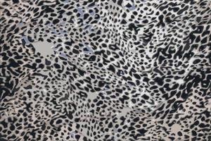 Realistic vector illustration of background with leopard texture, close up. Leopard dyed fabric.