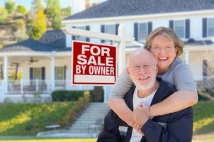 Senior Adult Couple in Front of Real Estate Sign, House photo