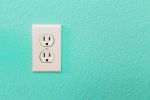 Electrical Sockets In Colorful Bright Teal Wall photo