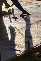 Construction Worker Smoothing Wet Cement With Trowel Tools photo