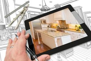 Hand on Computer Tablet Showing Photo of Kitchen Drawing Behind with Compass and Ruler