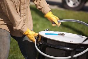 Worker Opening or Sealing Utility Drum photo