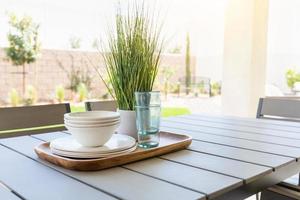 Outdoor Patio Setting with Dishes and Glasses on Tray photo