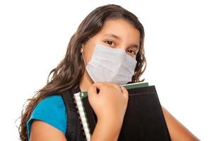 Hispanic Student Girl Wearing Face Mask with Books Isolated on White photo