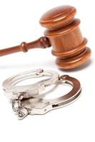 Gavel and Handcuffs on White photo