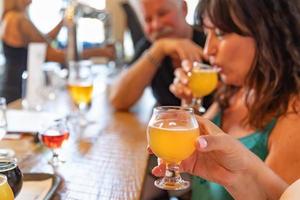 Group of Friends Enjoying Glasses of Micro Brew Beer At Bar photo