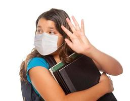 Hispanic Student Girl Wearing Face Mask with Books Isolated on White photo