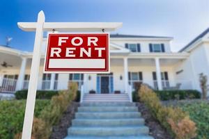 Right Facing For Rent Real Estate Sign In Front of House. photo