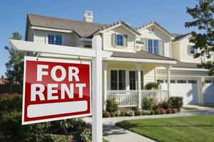 For Rent Real Estate Sign in Front of House photo