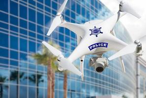 Police Unmanned Aircraft System, Drone Flying Near City Highrise Building photo