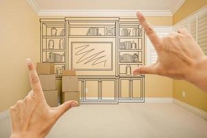 Hands Framing Drawing of Entertainment Unit In Empty Room photo
