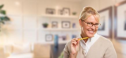 Beautiful Expressive Student or Businesswoman with Pencil in Office. photo