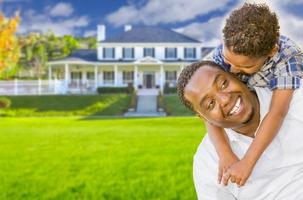 Mixed Race Father and Son In Front of House photo