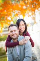 Outdoor Fall Portrait of Chinese and Caucasian Young Adult Couple. photo