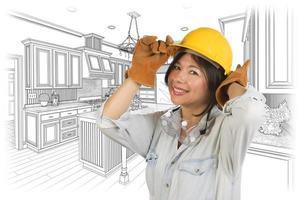 Hispanic Woman in Hard Hat with Kitchen Drawing Behind photo