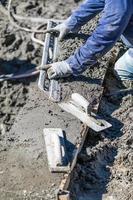 Pool Construction Worker Working With A Smoother Rod On Wet Concrete photo