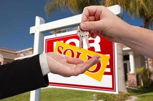 Agent Handing Over the Key to a New Home photo