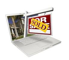 Sold Home for Sale Sign and New House Laptop photo