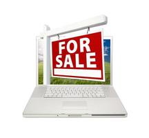en venta signo de bienes raíces en la computadora portátil foto