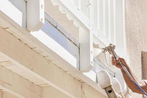 House Painter Spray Painting A Deck of A Home photo