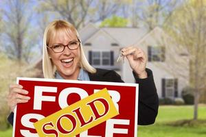 Woman with Sold Sign and Keys in Front of House photo