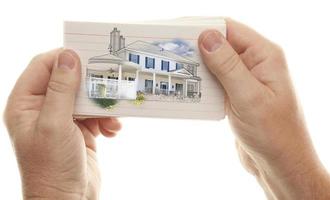 Male Hands Holding Stack of Flash Cards with House Drawing photo