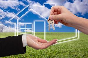 Handing Over Keys on Ghosted Home Icon, Grass Field and Sky photo