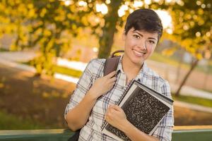 Portrait of a Pretty Mixed Race Female Student Holding Books photo