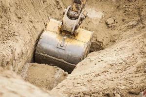 Excavator Tractor Digging A Trench photo