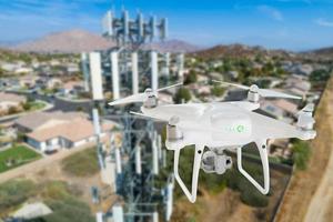 Unmanned Aircraft Drone Flying Near and Inspecting Cell Tower photo