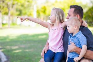 Young Caucasian Dad, Son and Daughter Having Fun In The Park photo