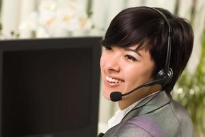 Attractive Young Woman Smiles Wearing Headset photo