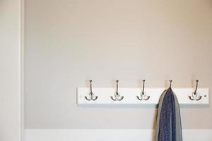 Wall in House with Scarf Hanging on Coat Rack Hooks Abstract photo