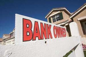 Bank Owned Real Estate Sign and House with American Flag photo