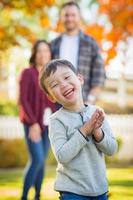 Outdoor Portrait of Happy Mixed Race Chinese and Caucasian Parents and Child. photo