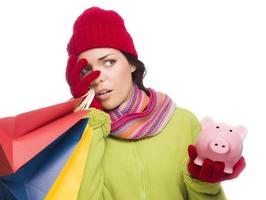 Concerned Expressive Mixed Race Woman Holding Shopping Bags and Piggybank photo