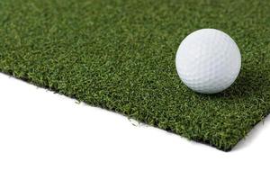 Golf Ball Resting on Section of Artificial Turf Grass On White Background photo