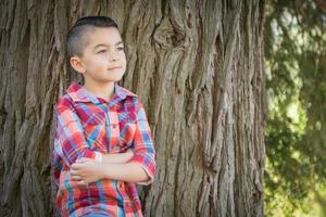 Mixed Race Young Boy Standing Outdoors. photo