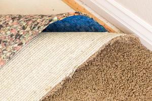 Pulled Back Carpet and Padding In Room photo