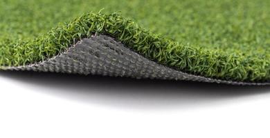 Flipped Up Section of Artificial Turf Grass On White Background photo