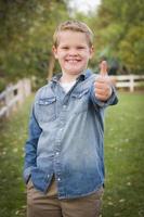 Handsome Young Boy Giving the Thumbs Up photo